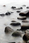 stones in the water in denmark on the north coast of the seeland island, slow shutter speed