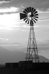 Windmill as the sun sets over the mountains.